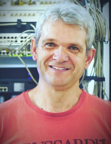 a woman wearing glasses and a grey blazer