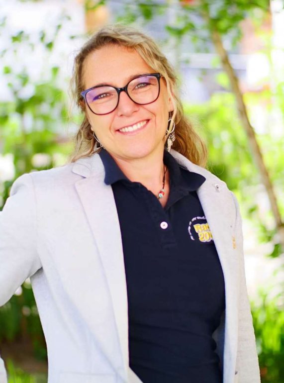a woman wearing glasses and a grey blazer