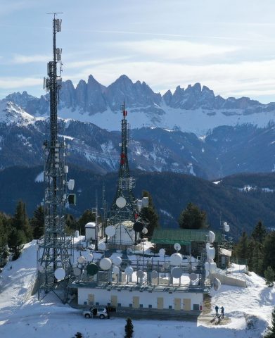 a building with antennas on top of a mountain